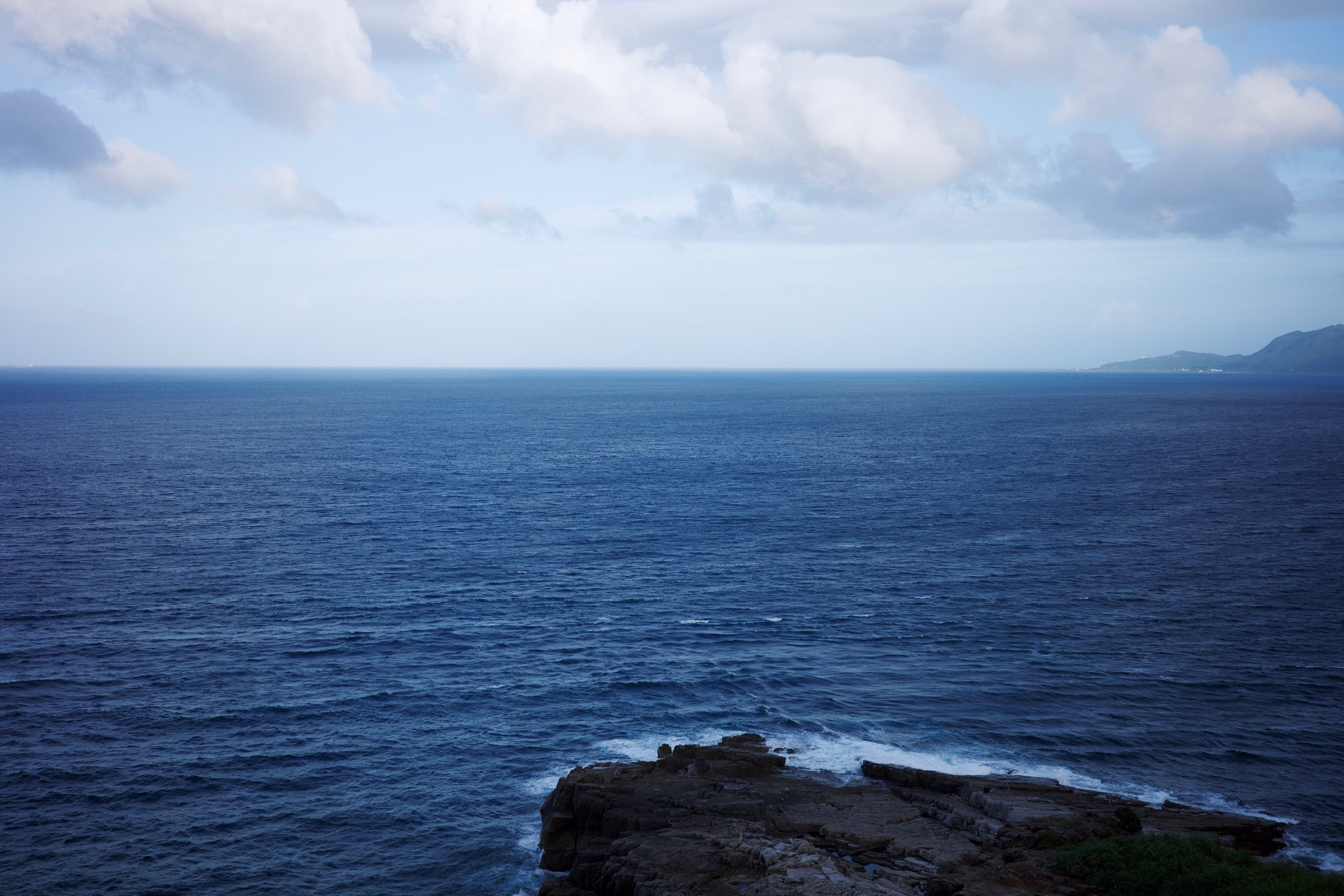 View of the East China Sea from the North East point of Taiwan. Just ocean and a blue sky.