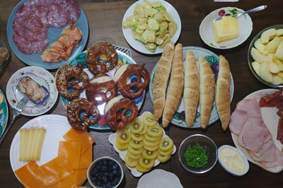Brunch spread with bread and cold cuts.
