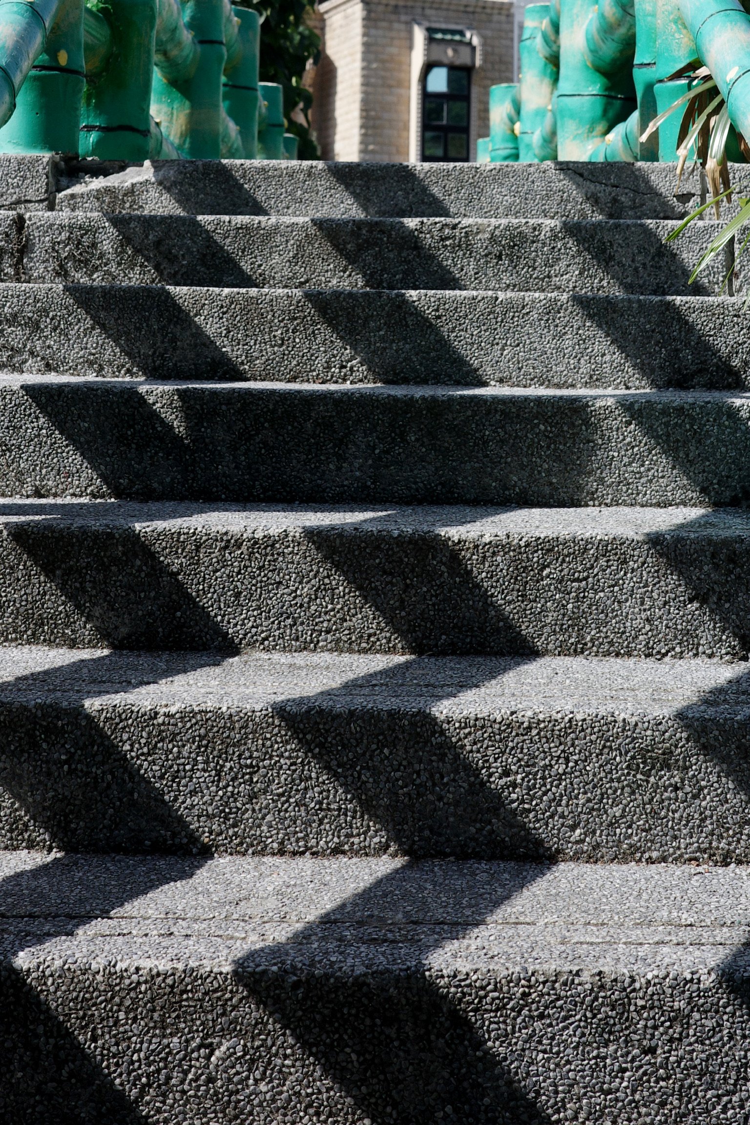 Zig zag shadows on steps of stairs.